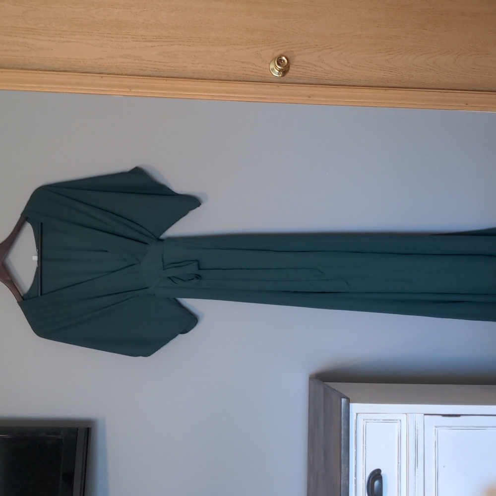 Medium emerald green wrap dress with deep v neck and flutter sleeves